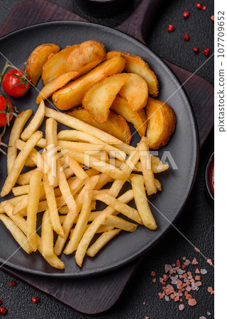 Fresh delicious crispy French fries with salt and spices Fresh delicious crispy French fries with salt and spices 107709652