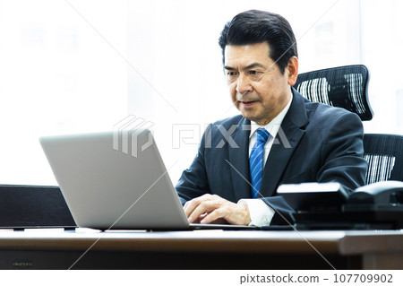 Manager working on a computer in the office 107709902