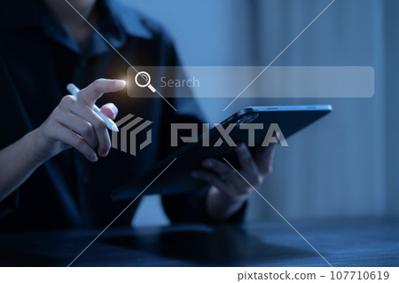 Male businessman clicking internet search page on computer and smart phone touch screen in the office. Male businessman clicking internet search page on computer and smart phone touch screen in the office. 107710619