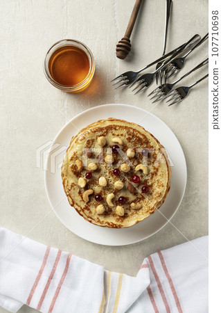 Large pancakes on light stone background Large pancakes on light stone background 107710698