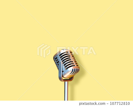 retro condenser microphone, isolated on yellow retro condenser microphone, isolated on yellow 107712810