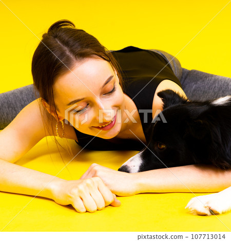 Friendship between people and animals, studio shot, love, tender, warm feeling and emotion 107713014