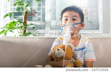 Asian Child using nebulizer mask equipment alone have smoke, Kid boy making makes inhalation nebulizer steam sick cough at home, oxygen spray inhaler therapy, stuffy nose and runny, Health medical Asian Child using nebulizer mask equipment alone have smoke, Kid boy making makes inhalation nebulizer steam sick cough at home, oxygen spray inhaler therapy, stuffy nose and runny, Health medical 107713593