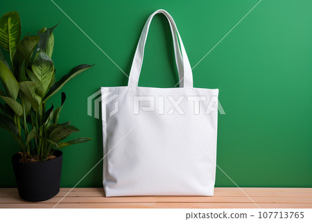 White tote bag mockup on green background. Shopper handbag. Template blank cotton shopping eco reusable bag. Green Friday, sale accessories. Minimalist eco friendly design, zero waste movement concept 107713765