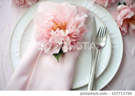 Beautiful table setting with flower decorations. Dishware, silverware and decorations on festive table, dinner table prepared for wedding or party, home table decoration Beautiful table setting with flower decorations. Dishware, silverware and decorations on festive table, dinner table prepared for wedding or party, home table decoration 107713789