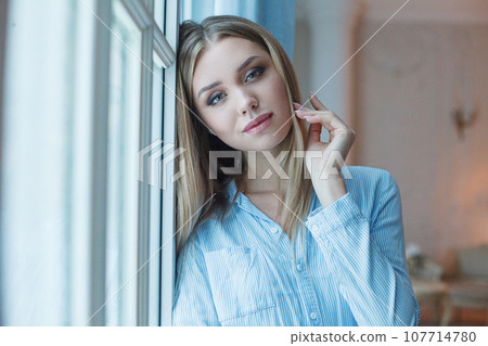 Beautiful lady with healthy blonde hair and makeup. Indoor portrait of young perfect woman 107714780