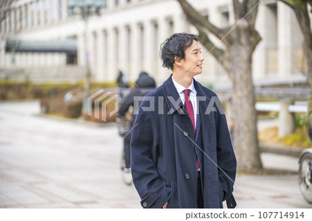 Businessman walking in town Businessman walking in town 107714914