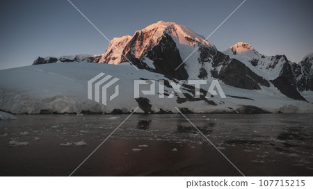Lemaire strait coastal landscape, mountains and icebergs, Antarctic Peninsula, Antartica. 107715215