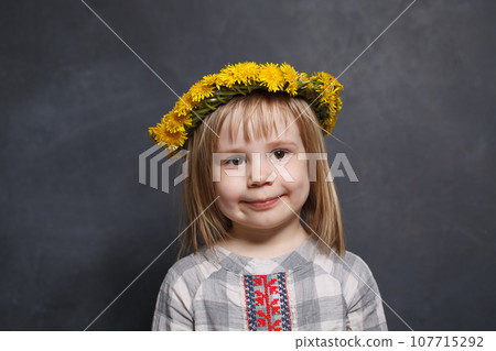 Adorable little girl with yellow dandelion flowers portrait Adorable little girl with yellow dandelion flowers portrait 107715292