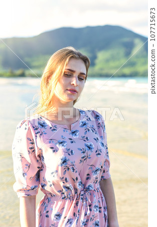Beautiful Belarus woman walking on the beach against dramatic and romantic sky Beautiful Belarus woman walking on the beach against dramatic and romantic sky 107715673
