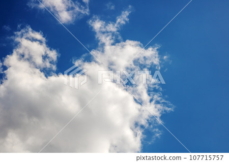White clouds in a blue bright sky 107715757