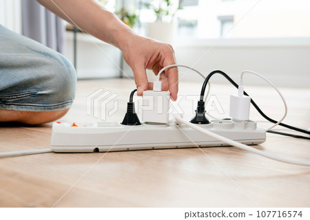 Electrical plug in outlet socket at home Electrical plug in outlet socket at home 107716574