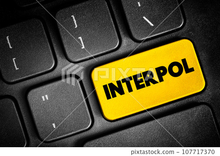 Interpol - international organization that facilitates worldwide police cooperation and crime control, text button on keyboard, concept background 107717370