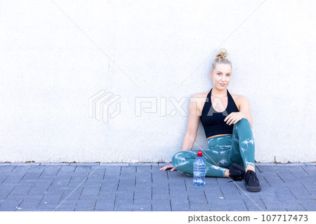 Sporty Millennial Woman Resting After Exercise 107717473