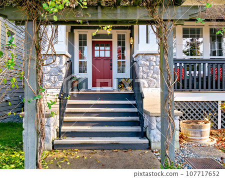 A perfect neighbourhood. Porch and entrance of a nice residential house 107717652