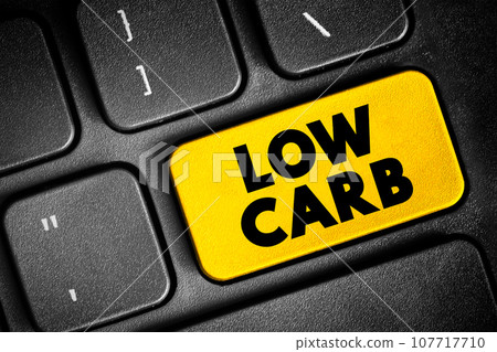 Low Carb - diet means that you eat fewer carbohydrates and a higher proportion of protein and fat, text concept button on keyboard 107717710