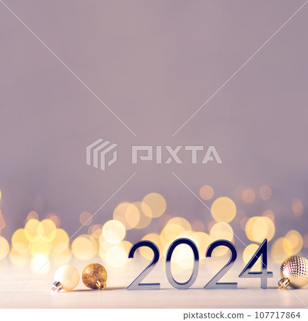 Metal numbers 2024 on table with bokeh lights. Metal numbers 2024 on table with bokeh lights. 107717864