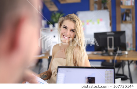 Portrait of smiling woman at work table Portrait of smiling woman at work table 107720144