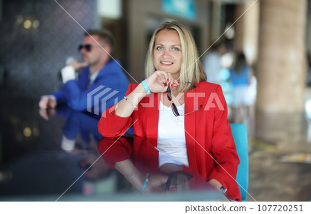 Portrait of businesswoman in red jacket at bar Portrait of businesswoman in red jacket at bar 107720251