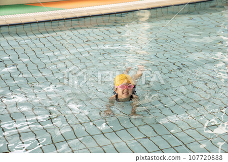 girl swimming in children's pool girl swimming in children's pool 107720888