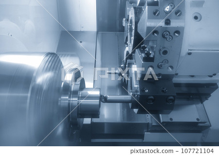 The CNC lathe machine bore cutting the metal shaft parts. The CNC lathe machine bore cutting the metal shaft parts. 107721104