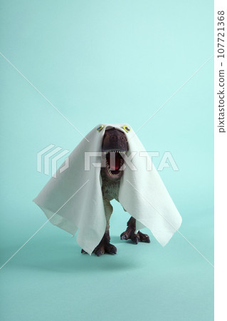 a plastic t-rex dinosaur figurine disguised as a ghost with a sheet and false eyes a plastic t-rex dinosaur figurine disguised as a ghost with a sheet and false eyes 107721368