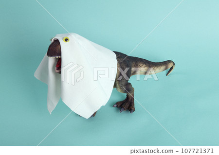 a plastic t-rex dinosaur figurine disguised as a ghost with a sheet and false eyes a plastic t-rex dinosaur figurine disguised as a ghost with a sheet and false eyes 107721371