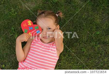 A child with a postcard for the April World Awareness Day about Autism A child with a postcard for the April World Awareness Day about Autism 107721654