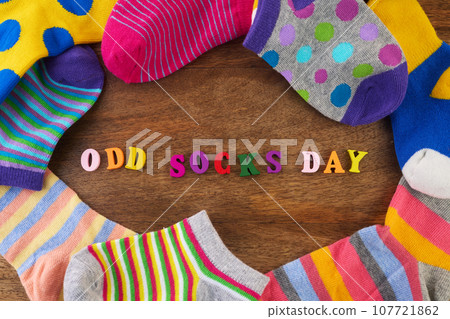 Odd Socks Day. Day lost socks, lonely socks on wooden background. 107721862