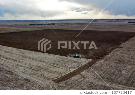 Agricultural machinery in the field, aerial view. Agricultural work. Agricultural machinery in the field, aerial view. Agricultural work. 107723417
