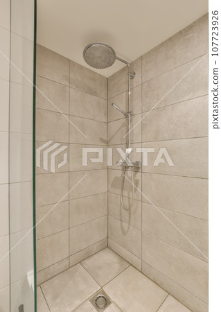 a shower with white tiles on the wall and green trim around the door, in a bathroom reurre 107723926