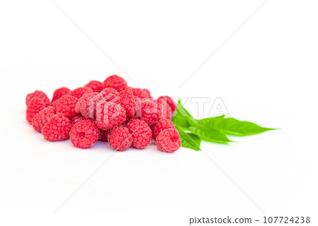 Fresh raspberry with green leaves on white background 107724238