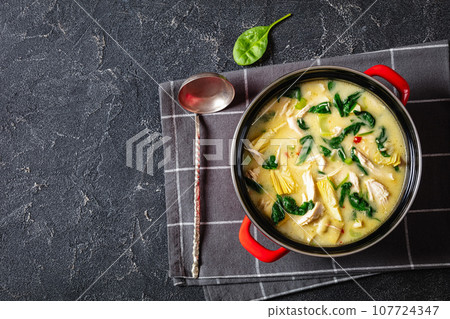 chicken spinach artichoke creamy soup in a pot 107724347