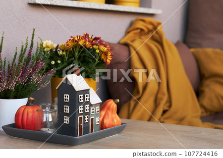 Cozy Place to Relax on Balcony or Terrace with Cute Autumn Hygge Home Decor and Blooming Flowers. Cozy Place to Relax on Balcony or Terrace with Cute Autumn Hygge Home Decor and Blooming Flowers. 107724416