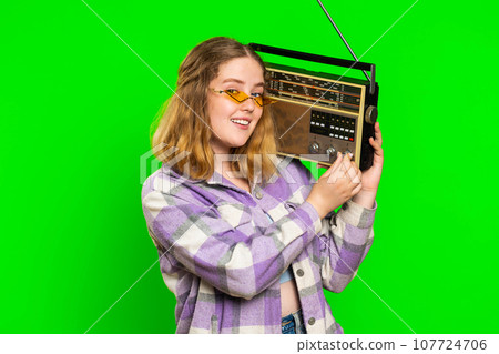 Happy woman listen music on retro tape record player, disco dancing, fan of vintage technologies 107724706