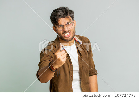 Irritated displeased aggressive unhappy Indian man gesturing hands blaming scolding failure problem 107724773