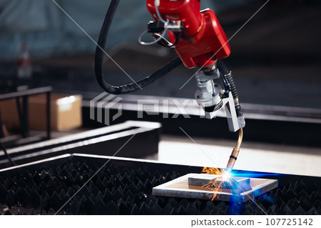 Closeup robot arm metal Argon Welding Machine working. Robotic technology in precious automation and manufacturing industry Closeup robot arm metal Argon Welding Machine working. Robotic technology in precious automation and manufacturing industry 107725142