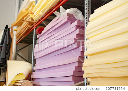 Stacked sheets of foam rubber for furniture production in factory workshop Stacked sheets of foam rubber for furniture production in factory workshop 107731634