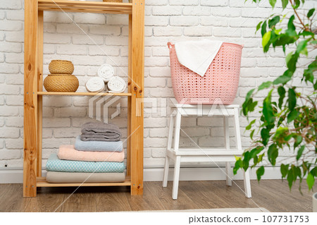 Pink plastic laundry basket in a bathroom 107731753