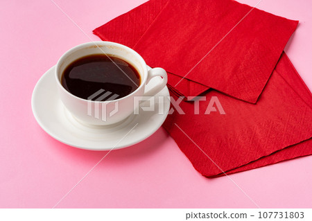 Coffee cup with paper napkins on pink background Coffee cup with paper napkins on pink background 107731803