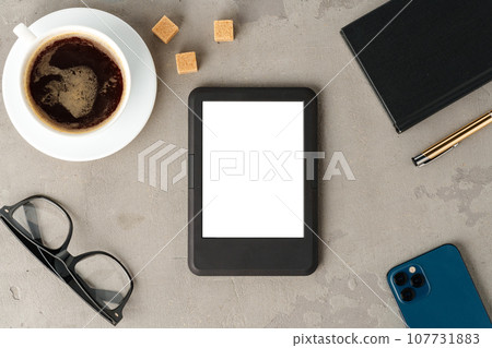 E-book reader with glasses on gray background close up 107731883