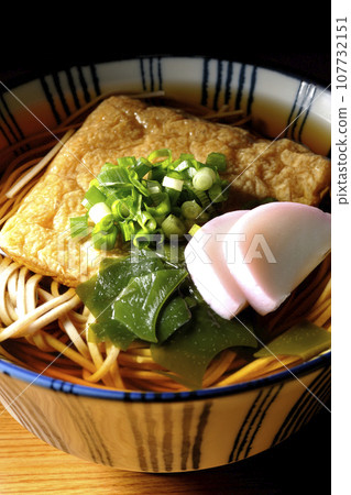 Kitsune soba with fried tofu, kamaboko, wakame, and green onion Kitsune soba with fried tofu, kamaboko, wakame, and green onion 107732151