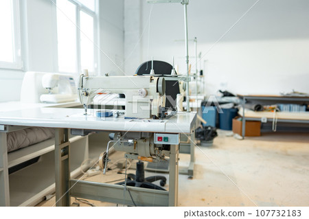 Interior of a sewing warehouse of furniture factory with equipment and materials Interior of a sewing warehouse of furniture factory with equipment and materials 107732183