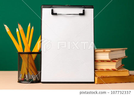 Blank clipboard with copy space and school supplies Blank clipboard with copy space and school supplies 107732337