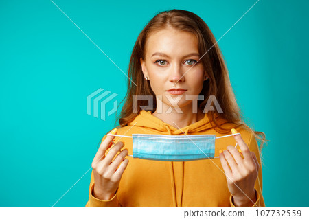 Young beautiful casual woman wearing protective medical mask Young beautiful casual woman wearing protective medical mask 107732559