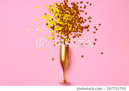 Champagne glass with confetti flat lay top view Champagne glass with confetti flat lay top view 107732793