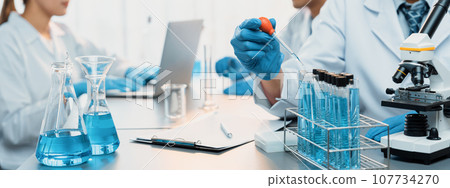 Group of dedicated scientist conduct chemical experiments in lab. Neoteric Group of dedicated scientist conduct chemical experiments in lab. Neoteric 107734270