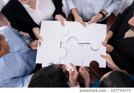 Diverse corporate officer workers connecting puzzle pieces. Concord 107734275