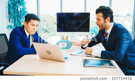 Two business people talk project strategy at office Jivy 107734458