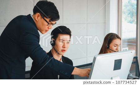 Business people wearing headset working in office Jivy Business people wearing headset working in office Jivy 107734527
